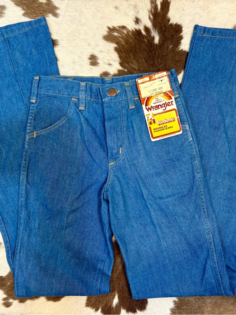 Wrangler blue denim jeans with orange stitching and vintage tag